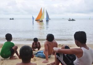 Sejumlah anak sedang menyaksikan Lomba Sampan Layar yang digelar di Pulau Buru, beberapa waktu lalu. (ft dok lendoot)