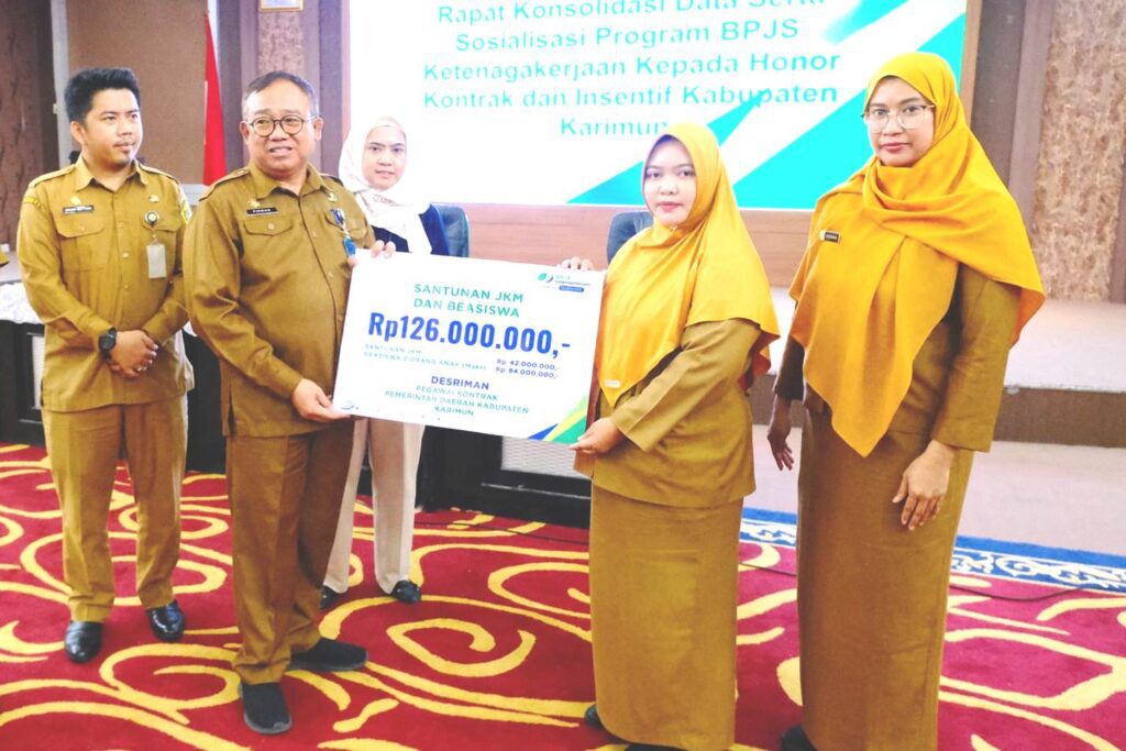 Sekda saat menyerahkan secara simbolik JKN dan beasiswa bagi honorer di Pemkab Karimun, kemarin. (ft kominfokarimun(