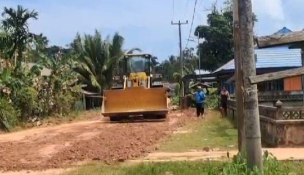 Alat berat perusahaan yang membantu memperbaiki jalan dan jembatan di Desa Teluk, pagi tadi, (ft gafar)